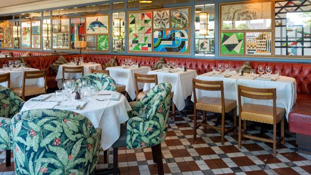 Tables and chairs in the colourful dining area. Image courtesy of The Ivy Collection. Tables and chairs in the colourful dining area. Image courtesy of The Ivy Collection.