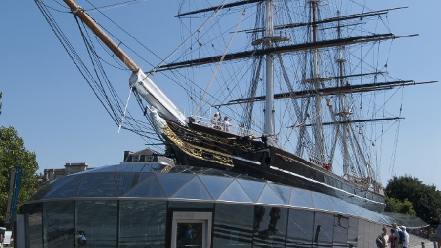 Cutty Sark exterior, with a glass structure surrounding the hull and the original ship on top.