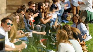 ESCP Europe summer school Students are sat outside a relaxing on a sunny day